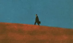 a banker walking uphill against a blue sky